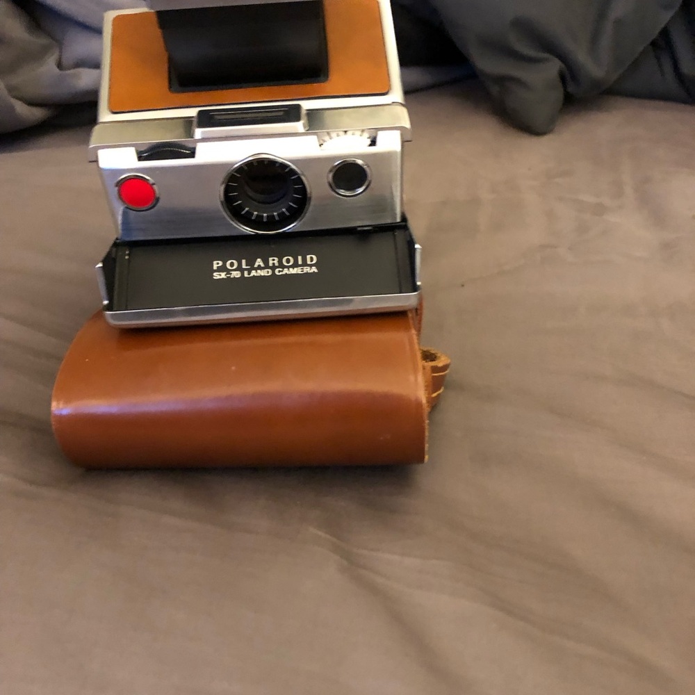 Polaroid Silver and Brown Film Photography Camera with Vintage Appeal